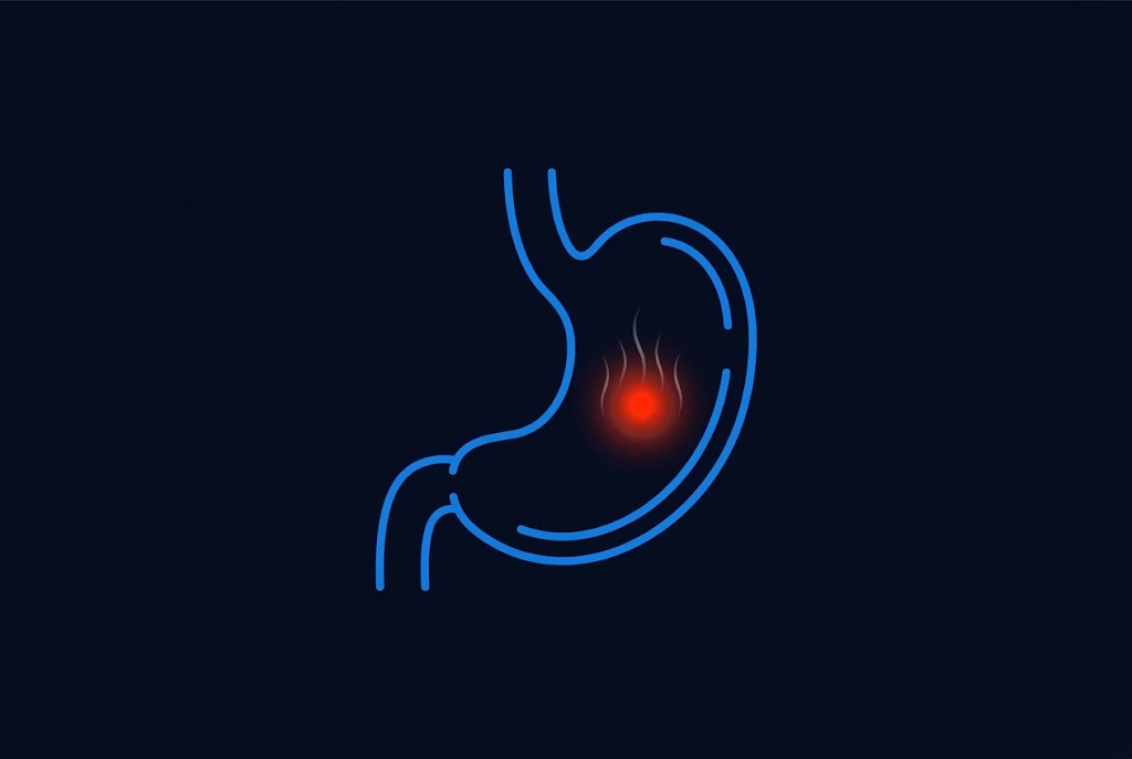Outline of a stomach with a glowing red spot on the lining and heat lines, representing a burning stomach from gastritis or an ulcer