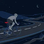 Flat illustration of a grey cyclist on a road bike riding along a winding road at night, with the bike saddle highlighted in red